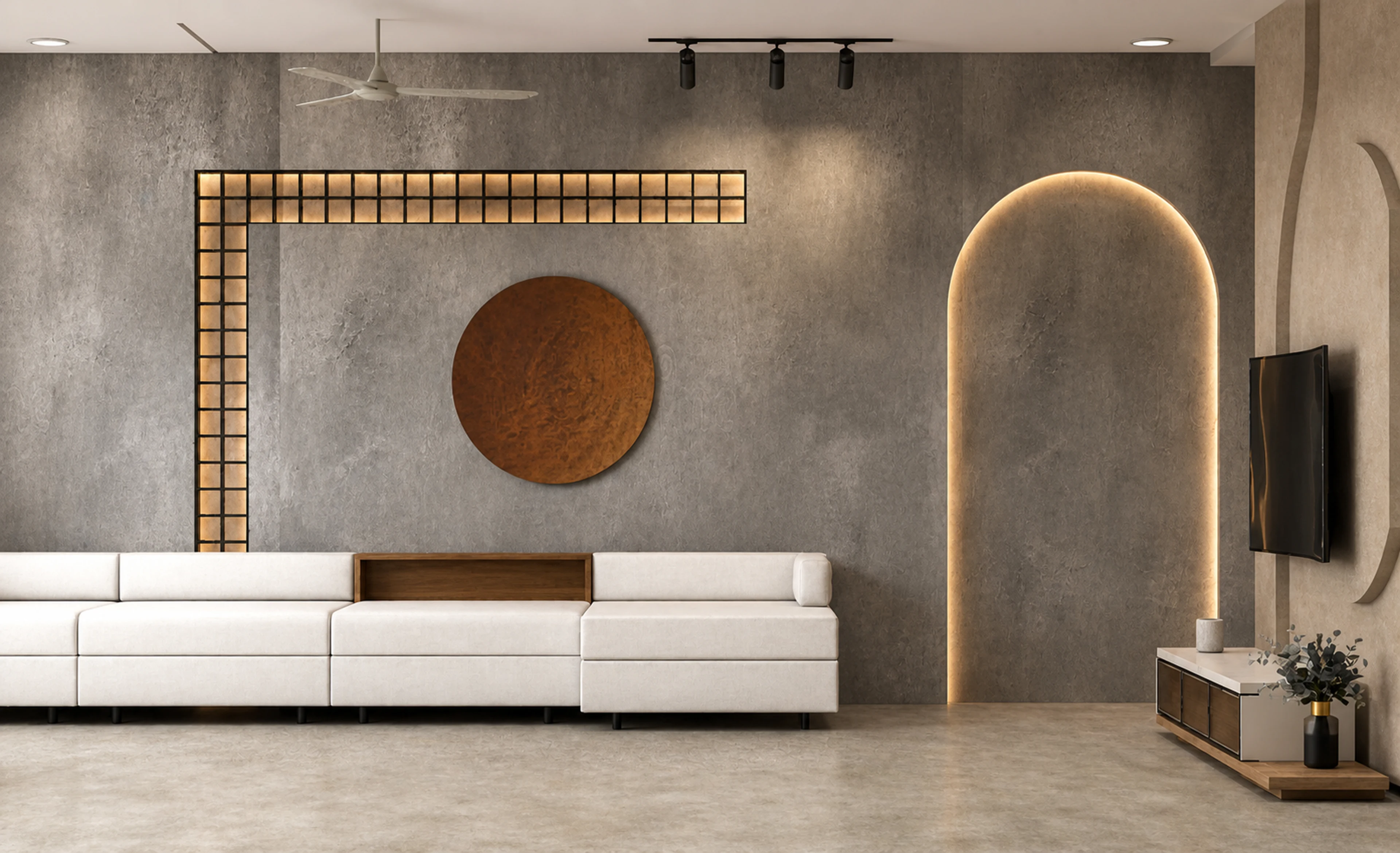The Quiet Home living room with a grey plaster feature wall, illuminated arch, warm grid detail, and ivory sectional seating