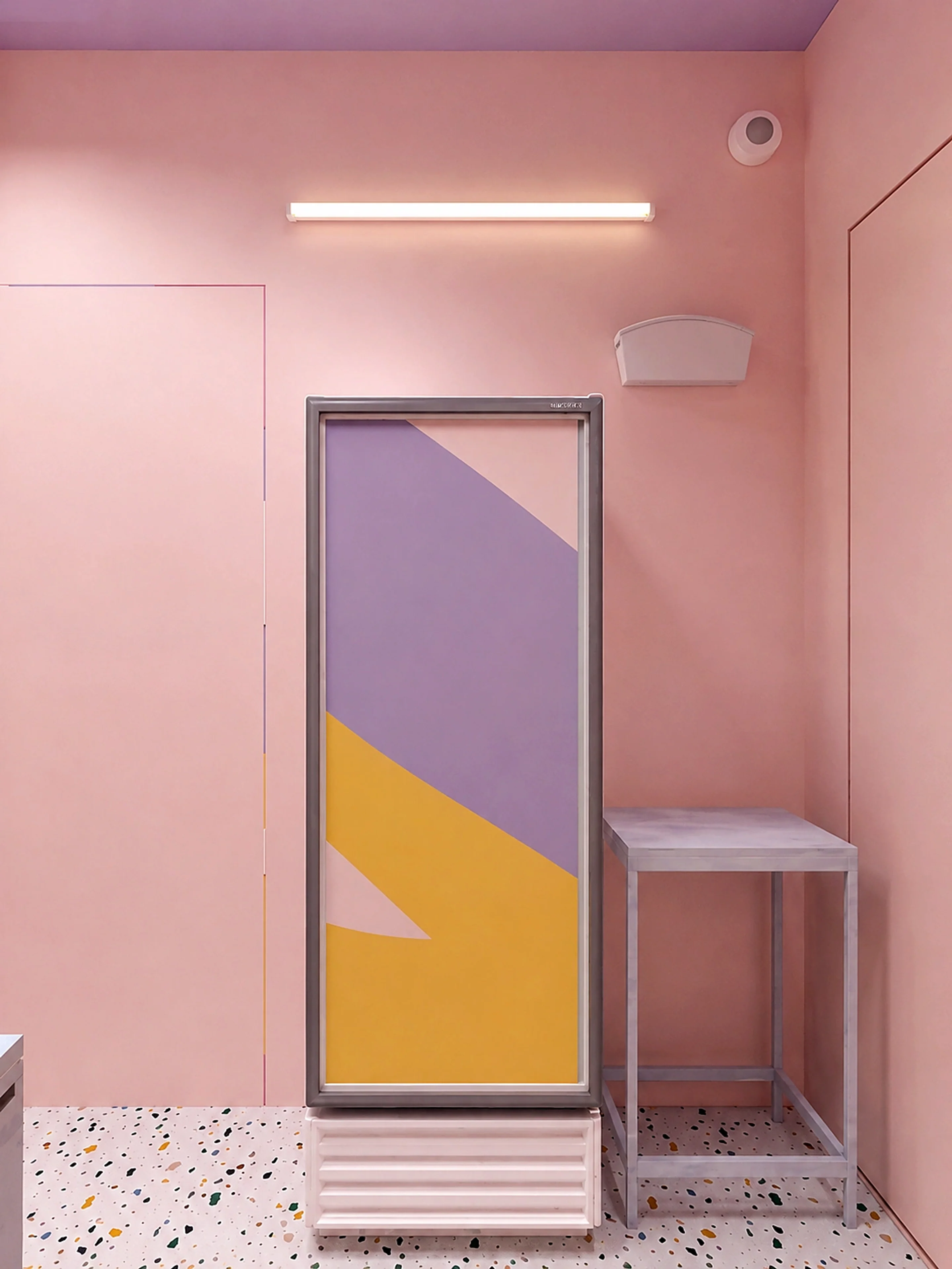 Cake shop pastel detail with soft pink walls, freezer unit, and terrazzo flooring